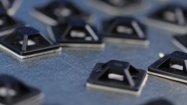 Plastic self-adhesive pad for installing nylon ties.
