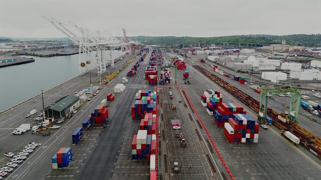 Aerial drone view of stacked shipping containers at cargo terminal