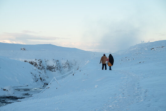 Tourists walking the paths of Reykjafoss waterfall in Skagafjordur in Iceland