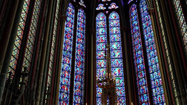Candlelit altar with stained glass windows inside Amiens Cathedral in France