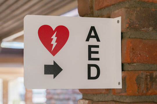 AED Emergency Defibrillator Location Sign Mounted On Brick Column