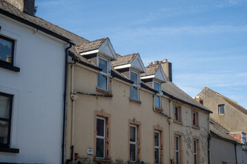 Obraz premium Old deteriorating terraced houses with dormer windows in Irish town