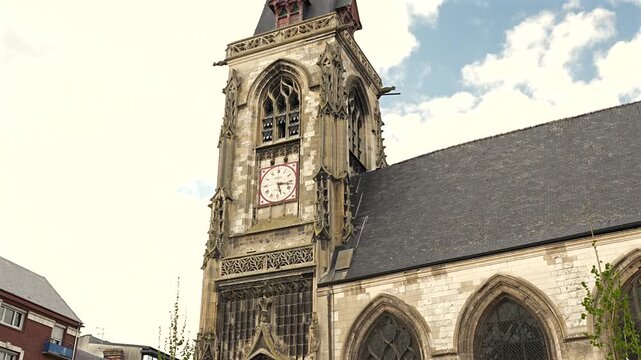 Amiens Cathedral exterior with gothic clock tower and pointed arch windows