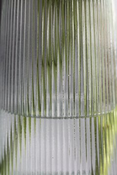 Close-up of textured ribbed glass surface with natural light