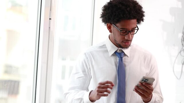 businessman with mobile phone and successful reaction