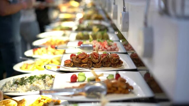 People Taking Food from Buffet Line at Event or Restaurant