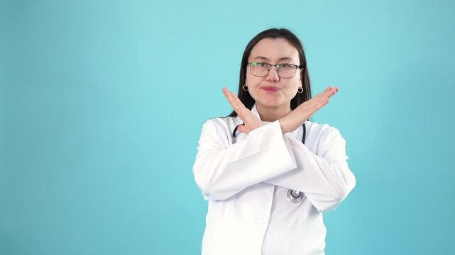 Confident female doctor making cross stop sign with her hands