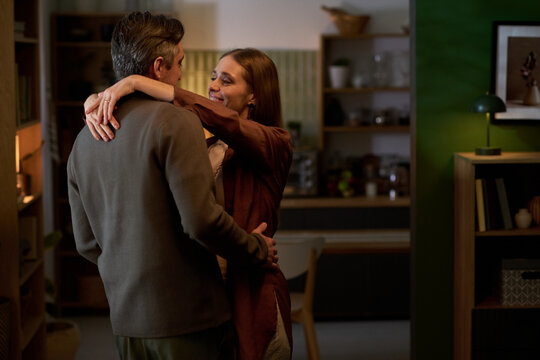 Couple embracing at home, expressing affection and relationship bonding. Ideal for marriage, dating, family lifestyle, love, partnership marketing campaigns