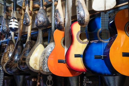 Colorful string instruments hanging in a market shop