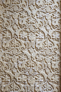 Intricate carved plaster pattern with floral arabesque design