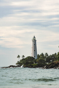 Dondra Head Lighthouse surrounded by palm trees on the coast of Sri Lanka