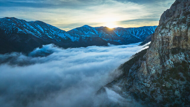 Aerial Mt Charleston Cloud Inversion at Sunset With Sunburst and Snowy Peaks