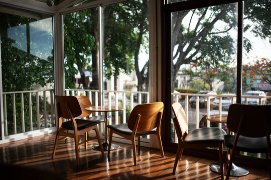 Cozy Cafe with Large Windows and Wooden Furniture