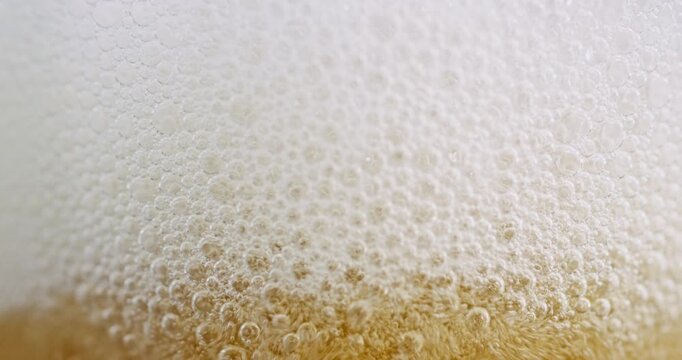Extreme Macro of White Beer Foam Head and Golden Carbonation Bubbles

