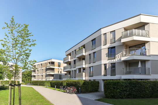 Cityscape of a residential area with modern apartment buildings, new sustainable development and green urban landscape in the city, concept for construction industry and real estate