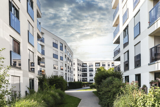 Cityscape of a residential area with modern apartment buildings, new sustainable development and green urban landscape in the city, concept for construction industry and real estate