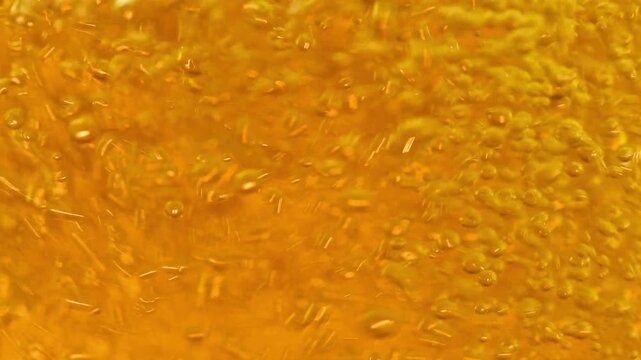 Extreme Macro of Effervescent Beer Bubbles and Golden Carbonation
