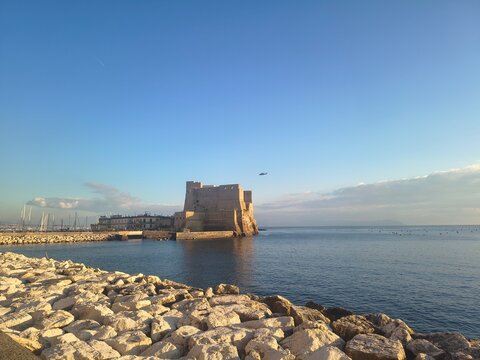 Seafront in Naples, Italy. Ovo Castle under blue sky
