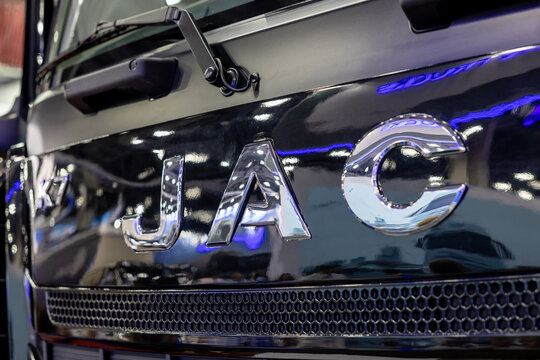 Chrome JAC logo emblem on a shiny black cabin of a modern tractor unit K7 model. Front view of a commercial heavy duty truck. Astana, Kazakhstan - May 30, 2024