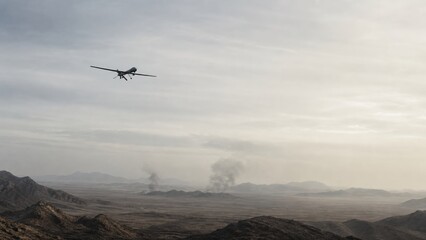Obraz premium Drone flies over a desert landscape with smoke rising from different areas in the distance during an operation in a conflict zone