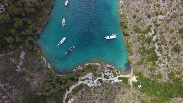 Aerial drone view of boats anchored in zavala cove on hvar island, croatia