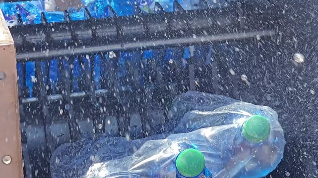 Industrial Shredder Machine Crushing Plastic Bottles for Recycling Close Up