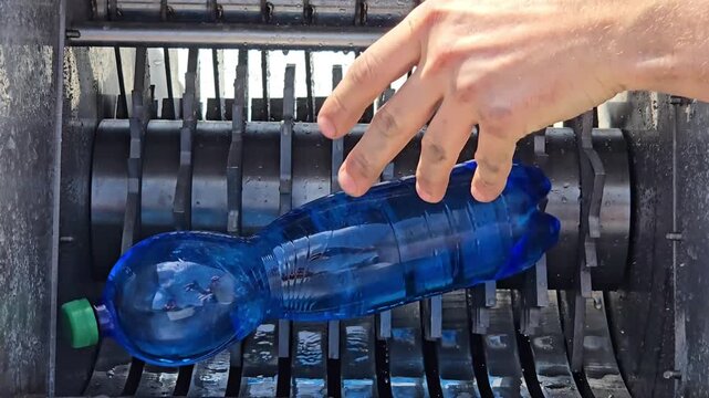 Industrial Shredder Machine Crushing Plastic Bottles for Recycling Close Up