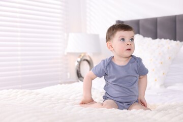 Fototapeta premium Cute little baby boy on bed at home. Space for text