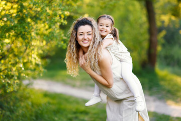 Fototapeta premium Mother with her cute little daughter in nature