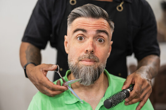 Client reacting to barber services in salon