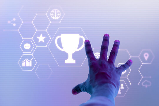 Hand reaching for a trophy icon among hexagonal digital icons