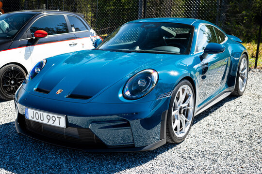 Djurhamn, Sweden - May 10, 2026: A contemporary Porsche 911 GT3 Touring (992 generation) finished in a striking metallic teal blue paint, captured at an outdoor event in Sweden