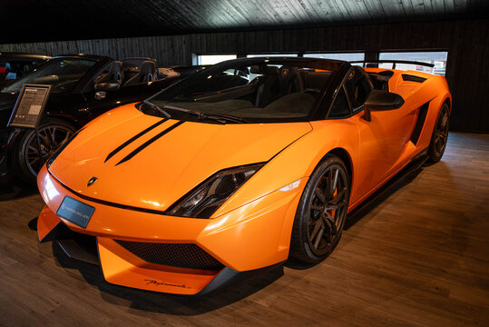 Djurhamn, Sweden - May 10, 2026: Orange Lamborghini Gallardo LP 570-4 Spyder Performante Supercar inside a luxury showroom in Sweden