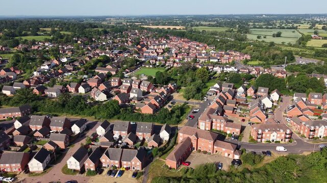 Aerial drone footage of Three Mile Cross in Berkshire, England, showcasing residential neighbourhoods, surrounding countryside, and suburban development