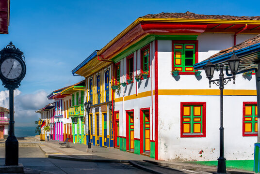 Colombia, Salento,a picturesque street corner features colorful painted houses and a street clock.
