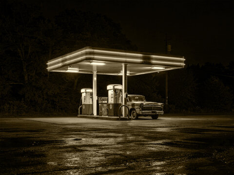  Deserted gas station in rural America with lights at night