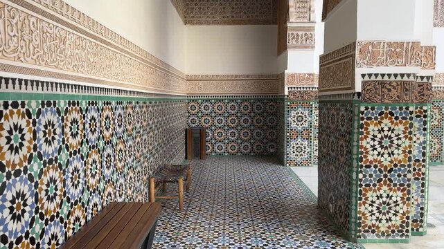 Ornate Islamic courtyard doorway with mosaic tiles at Ben Youssef Madrasa Marrakech