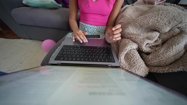 Woman enjoying casual online study on sofa with bright natural light
