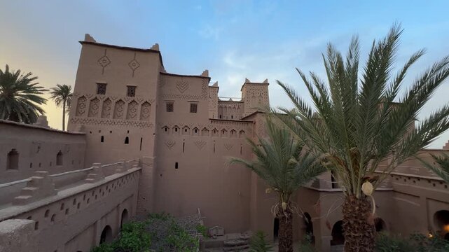 Ancient Kasbah Amridil fortress at dusk with traditional Moroccan mudbrick architecture