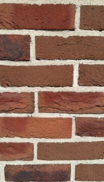 Multi color red brick wall texture background, rustic clinker brickwork backdrop with white grout for loft design
