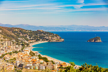 Fototapeta premium Aerial panoramic view of the coast of Spotorno, Bergeggi Island, Torre del Mare, Liguria, province of Savona, Italy. Riviera dei Fiori. Western Riviera. Ligurian Sea