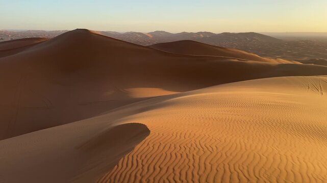 Golden sunrise over Sahara sand dunes near Merzouga, Morocco desert