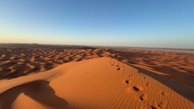 Golden sunrise over Sahara sand dunes near Merzouga, Morocco desert