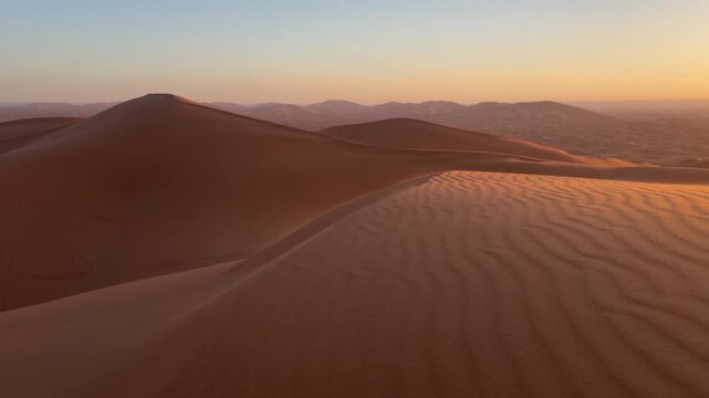 Golden sunrise over Sahara sand dunes near Merzouga, Morocco desert