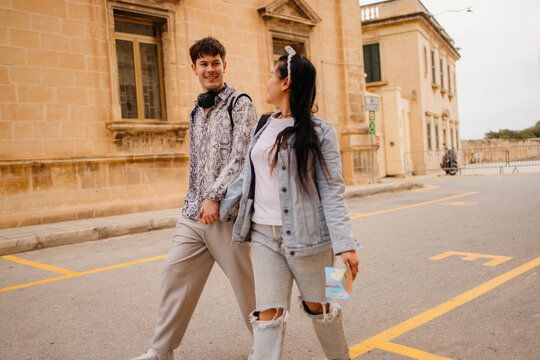 Happy couple enjoying in walk and talk on the street
