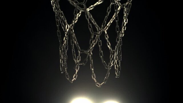 Basketball entering the hoop on an outdoor court at night with visible street light in the background. Urban sports atmosphere with dramatic lighting and cinematic night game feeling.
