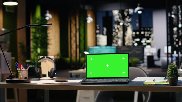 Green screen in empty executive office with contemporary design, comfortable desk setup and stylish furniture. Interior enhanced by natural light and panoramic view of skyscrapers downtown.