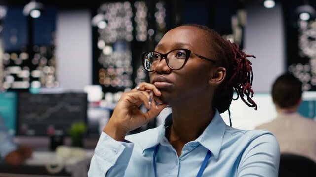 Businesswoman thinking deeply about new ideas and solutions, surrounded by laptop and documents. Analyzing research and data for administrative tasks, pensive to achieve business goals.