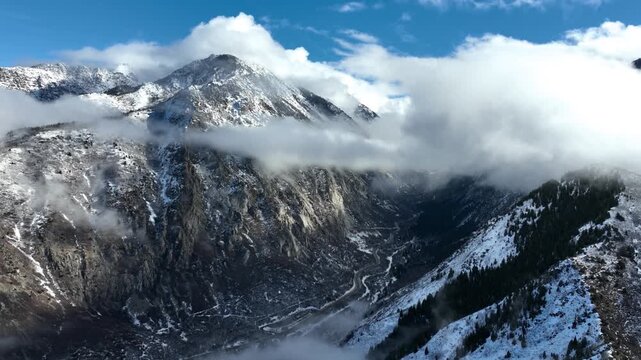 Aerial shot of the clouds and the rugged terrain of the Wasatch Mountains near Salt Lake City, Utah.