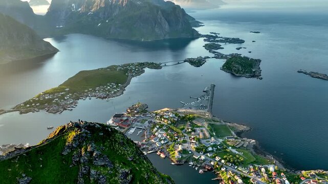 Aerial shot of the ocean meeting the mountains along the beautiful coast of Northern Norway near the town of Reine